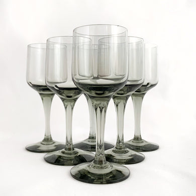 Set of eight vintage modernist style smoke gray Rhapsody sherry glasses. Crafted by Orrefors Glassworks, Sweden, 1967 - 1991. Add elegance to your barware collection with this stunning blown glass stemware.

In excellent condition, no chips.

Measures 2 3/8 x 5 3/4 inches

Capacity 4 ounces