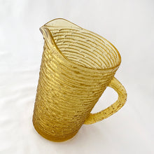 Load image into Gallery viewer, Enjoy freshly made beverages with this vintage &quot;Soreno Gold&quot; pressed glass pitcher. Made with a textured bark pattern and a luminous gold colour, it&#39;s perfect for serving juice, lemonade, or ice tea. Produced by Anchor Hocking Glass Company, USA between 1966-1970.  In excellent condition - free from chips or cracks.  Measures 4 x 7 inches  Capacity of 1 litre or quart
