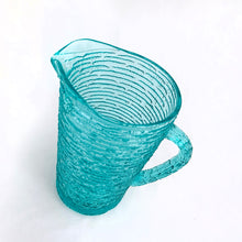 Load image into Gallery viewer, This vintage pressed glass pitcher is perfect for juice, lemonade, ice tea or your favourite beverage. Made in the &quot;Soreno&quot; pattern in luminous aquamarine with a textured bark outer surface. Made by Anchor Hocking between 1966–1970.  In excellent condition, free from chips or cracks.  Measures 7&quot; and holds 1 litre or 1 quart
