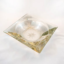 Load image into Gallery viewer, This heavy square clear glass bowl has a lovely cut starburst on the bottom. This particular design resembles vintage ashtrays, but it doesn&#39;t have channels to hold cigarettes/cigars. Would make a fabulous catchall or candy dish. It&#39;s a great conversation starter too!  In excellent condition free from chips or cracks.  Measures 7&quot; x 7&quot; x 2&quot;

