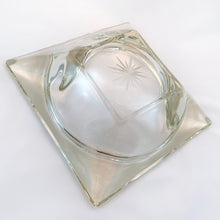 Load image into Gallery viewer, This heavy square clear glass bowl has a lovely cut starburst on the bottom. This particular design resembles vintage ashtrays, but it doesn&#39;t have channels to hold cigarettes/cigars. Would make a fabulous catchall or candy dish. It&#39;s a great conversation starter too!  In excellent condition free from chips or cracks.  Measures 7&quot; x 7&quot; x 2&quot;
