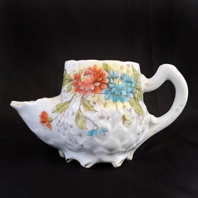 This vintage white porcelain shaving mug has an interesting artichoke embossed pattern with orange and blue strawflowers.   Stamped 