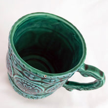 Load image into Gallery viewer, Lovely glazed ceramic teal coloured mug with raised floral medallions, rope details and a sculpted handle. Produced by Noritake for Gift Craft, circa 1950. Use as intended or repurpose as a decorative pencil or make-up brush holder.  In excellent vintage condition, free from chips/cracks.
