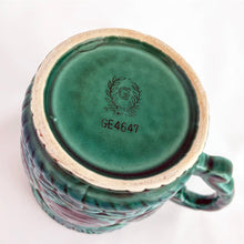Load image into Gallery viewer, Lovely glazed ceramic teal coloured mug with raised floral medallions, rope details and a sculpted handle. Produced by Noritake for Gift Craft, circa 1950. Use as intended or repurpose as a decorative pencil or make-up brush holder.  In excellent vintage condition, free from chips/cracks.

