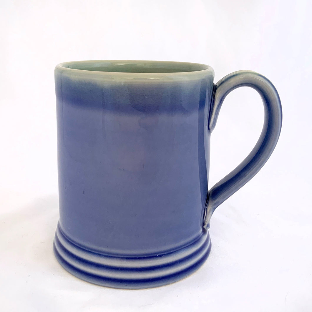 This vintage style mug is glazed in blue with a watery blue/green interior and a ribbed handle. Hand crafted by Thomas Aitken of AitkenHyde, Canada.  In excellent condition.  Measures 3 1/8 x 4 inches