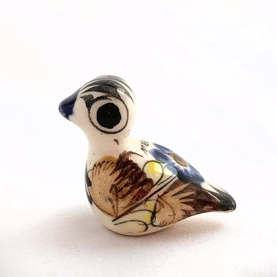 Beautiful Mexican Tonala miniature folk art pottery duck bird figurine. This hand painted figurine is white with a nicely detailed face in black and blue with the body in yellow, blue and brown florals. Signed 
