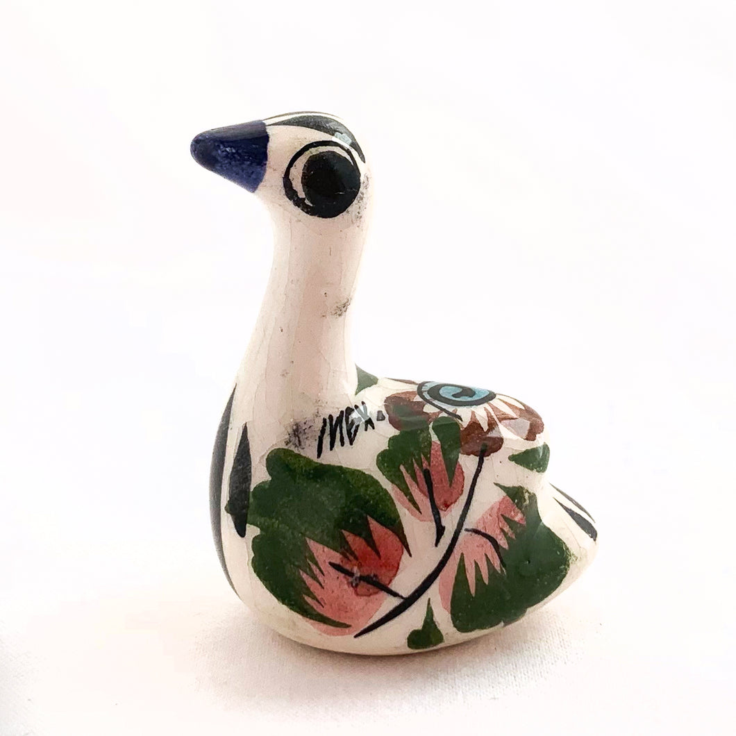 Beautiful Mexican Tonala miniature folk art pottery swan bird figurine. This hand painted figurine is white with a nicely detailed face in black and blue with the body in pink, blue, green and brown florals. Signed 