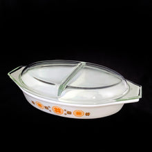 Load image into Gallery viewer, Vintage &quot;Town and Country&quot; divided casserole lidded baking/serving dish in the colours of brown and orange starbursts on white. Possibly designed by Philip Johnson for PYREX. Produced by Corning Glass Works, USA,  1963-1967. The perfect cooking and storage solution!  In excellent condition, free from chips/cracks. Colours are vibrant.  Casserole measures 12 1/2 x 8 1/2 x 2 inches  Lid 12 3/4 x 8 3/8 x 1 7/8 inches
