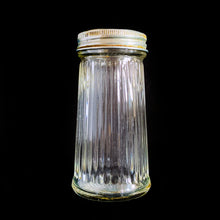 Load image into Gallery viewer, Vintage vertically ribbed clear depression glass shaker with metal lid. Use for salt, pepper or your favourite spice. Produced by the Dominion Glass Company, Canada, circa 1950s.  In good vintage condition, embossed makers mark of a &#39;D&#39; inside a diamond on the bottom.  Measures 2 x 3 7/8 inches
