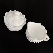 Load image into Gallery viewer, Vintage white milk glass is the epitome of simple elegance! This is a scalloped creamer and lidded sugar bowl in the &quot;Hobnail&quot; pattern. Produced by Fenton, post 1970. Marked.  The creamer is in excellent condition, free from chips or cracks. The sugar bowl has a chip on the side of one of the scalloped points...it&#39;s not rough or really noticeable thanks to the piece being white.  Creamer measures 4&quot; 3-1/2&quot;, sugar w/ lid measures 4&quot; x 4-3/4&quot;
