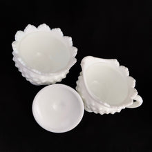 Load image into Gallery viewer, Vintage white milk glass is the epitome of simple elegance! This is a scalloped creamer and lidded sugar bowl in the &quot;Hobnail&quot; pattern. Produced by Fenton, post 1970. Marked.  The creamer is in excellent condition, free from chips or cracks. The sugar bowl has a chip on the side of one of the scalloped points...it&#39;s not rough or really noticeable thanks to the piece being white.  Creamer measures 4&quot; 3-1/2&quot;, sugar w/ lid measures 4&quot; x 4-3/4&quot;

