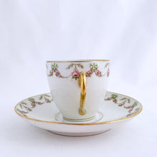 Load image into Gallery viewer, Pretty white porcelain demitasse cup and saucer hand painted with pink and green floral swags with gold trim. Produced by L. Bernardaud &amp; Co., Limoges, France for Birks.  Tiniest of flea nicks on one cup. Remaining pieces are in excellent condition, free from chips/cracks/repairs.  Dimensions of cups 2-3/8&quot; x 2-1/8&quot; and saucers 4-5/8&quot;
