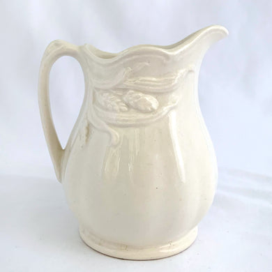 A pretty white ironstone ceramic cream pitcher embossed with a wheat pattern. Produced by Wilkinson Brothers in Staffordshire District, England.  In excellent condition, no chips, cracks or repairs.  Measures 3-1/4
