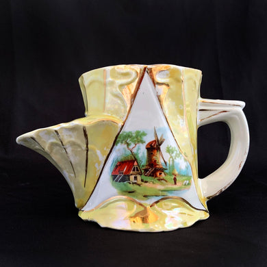 This vintage white porcelain shaving scuttle mug is hand painted with windmill and barn scene inside a gold triangle surrounded with yellow. The mug has raised art nouveau details. Use as intended or repurpose as a toothbrush or make-up brush holder.  Marked 