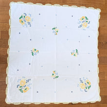Load image into Gallery viewer, Vintage crewel embroidered tablecloth with flowers in sunny shades of yellow and blue with green accents and edged in a crocheted border.  In good vintage condition with one small repair.  Measures 41 x 41 inches
