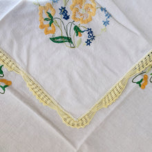 Load image into Gallery viewer, Vintage crewel embroidered tablecloth with flowers in sunny shades of yellow and blue with green accents and edged in a crocheted border.  In good vintage condition with one small repair.  Measures 41 x 41 inches
