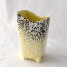 Load image into Gallery viewer, Fantastic atomic shaped mid-century white spatter ware footed vase in butter yellow graduating to brown. Marked &quot;USA&quot; on the bottom. Possibly Brush McCoy or American Bisque. A great decor piece that would be beautiful with either a fresh or dried floral arrangement.  In good vintage condition. Small flea bit on the rim which is barely noticeable amongst the splatter.   Measures 4 x 3 x 6 1/2 inches
