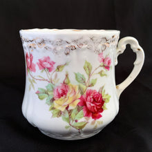 Load image into Gallery viewer, Vintage white porcelain shaving mug with pink and yellow roses with pink and gold around the rim and handle. Use as intended or repurpose as a toothbrush, make-up brush holder.  Maker unknown. Likely German made.  In excellent condition, no chips/cracks/repairs. Some wear to the gold.  Dimensions: 3-1/2&quot; x 3-5/8&quot;
