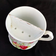 Load image into Gallery viewer, Vintage white porcelain shaving mug with pink and yellow roses with pink and gold around the rim and handle. Use as intended or repurpose as a toothbrush, make-up brush holder.  Maker unknown. Likely German made.  In excellent condition, no chips/cracks/repairs. Some wear to the gold.  Dimensions: 3-1/2&quot; x 3-5/8&quot;
