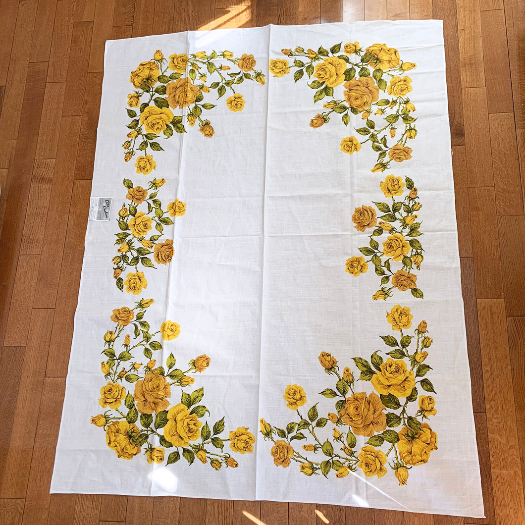 Vintage rectangular ecru linen/cotton tablecloth hand printed with yellow roses and green leaves. Produced by Elite Creation, Canada, circa 1970s.  In excellent condition. Never used. Original label.  Measures 51 x 68 Inches