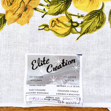 Load image into Gallery viewer, Vintage rectangular ecru linen/cotton tablecloth hand printed with yellow roses and green leaves. Produced by Elite Creation, Canada, circa 1970s.  In excellent condition. Never used. Original label.  Measures 51 x 68 Inches
