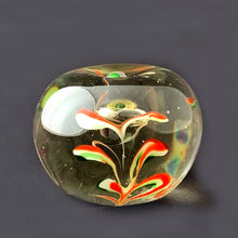 Load image into Gallery viewer, Red, green and white swirls form an iris flower inside this hand blown apple shaped paperweight with green stem. The bottom has a smoothened pontil mark. Unsigned.   In excellent condition, no chips or cracks.  Size: 3&quot; x 2-3/4&quot;
