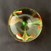 Load image into Gallery viewer, Red, green and white swirls form an iris flower inside this hand blown apple shaped paperweight with green stem. The bottom has a smoothened pontil mark. Unsigned.   In excellent condition, no chips or cracks.  Size: 3&quot; x 2-3/4&quot;
