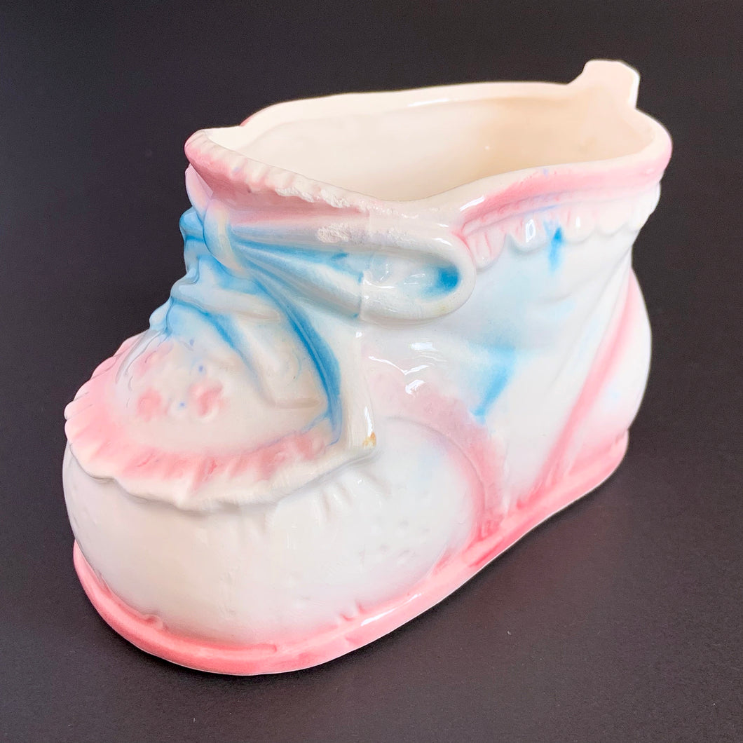 Vintage Rubens Originals white baby bootie planter with blue bows and pink details. A perfect addition to nursery decor!  Marked on the bottom with Rubens Originals stamp and sticker, made in Japan.  Excellent condition, no chips or cracks.  Size: 4