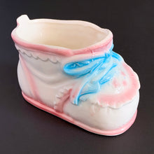 Load image into Gallery viewer, Vintage Rubens Originals white baby bootie planter with blue bows and pink details. A perfect addition to nursery decor!  Marked on the bottom with Rubens Originals stamp and sticker, made in Japan.  Excellent condition, no chips or cracks.  Size: 4&quot; x 2.25&quot; x 2.5&quot;
