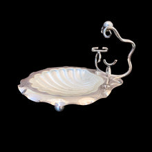 Load image into Gallery viewer, Antique shell-shaped silver plated butter dish with satin glass insert, bun feet and its raised scrolled rest is meant to hold a butter knife. What a special decorative dish to add a hint of elegance to your dining table.

Impressed hallmark EPNS ENGLAND the number 5 and an indiscernible curved mark, circa 1912.

In as found condition, no chips on the glass insert.

Measures 5 1/2 x 6 x 4 1/2 inches
