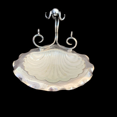 Antique shell-shaped silver plated butter dish with satin glass insert, bun feet and its raised scrolled rest is meant to hold a butter knife. What a special decorative dish to add a hint of elegance to your dining table.

Impressed hallmark EPNS ENGLAND the number 5 and an indiscernible curved mark, circa 1912.

In as found condition, no chips on the glass insert.

Measures 5 1/2 x 6 x 4 1/2 inches
