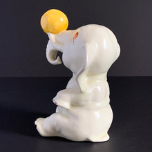 Load image into Gallery viewer, Who wouldn&#39;t love this adorable, art deco style figurine &#39;Circus Elephant&#39; balancing a vibrant  yellow ball on his trunk? Made by English Potter, Crown Devon, circa 1920/30, marked &quot;Made in England&quot;. I&#39;m told it&#39;s a rare piece.  The ceramic figurine is in excellent overall condition. No chips, cracks or repairs. There is some paint loss on the black details...see pics.  Measures 4&quot; x 5-1/2&quot;
