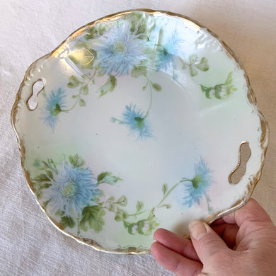 Lovely vintage hand painted porcelain cake plate featuring beautiful light blue aster flowers, gold gilt rim with handles. Marked 