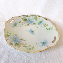 Load image into Gallery viewer, Lovely vintage hand painted porcelain cake plate featuring beautiful light blue aster flowers, gold gilt rim with handles. Marked &quot;Hand Painted&quot;. Produced in Japan. A nice piece for serving cakes and pastries, or hang as wall art.  In excellent condition, free from chips. There appears to be a stable crack which does not affect use or beauty.  Measures 10 inches   
