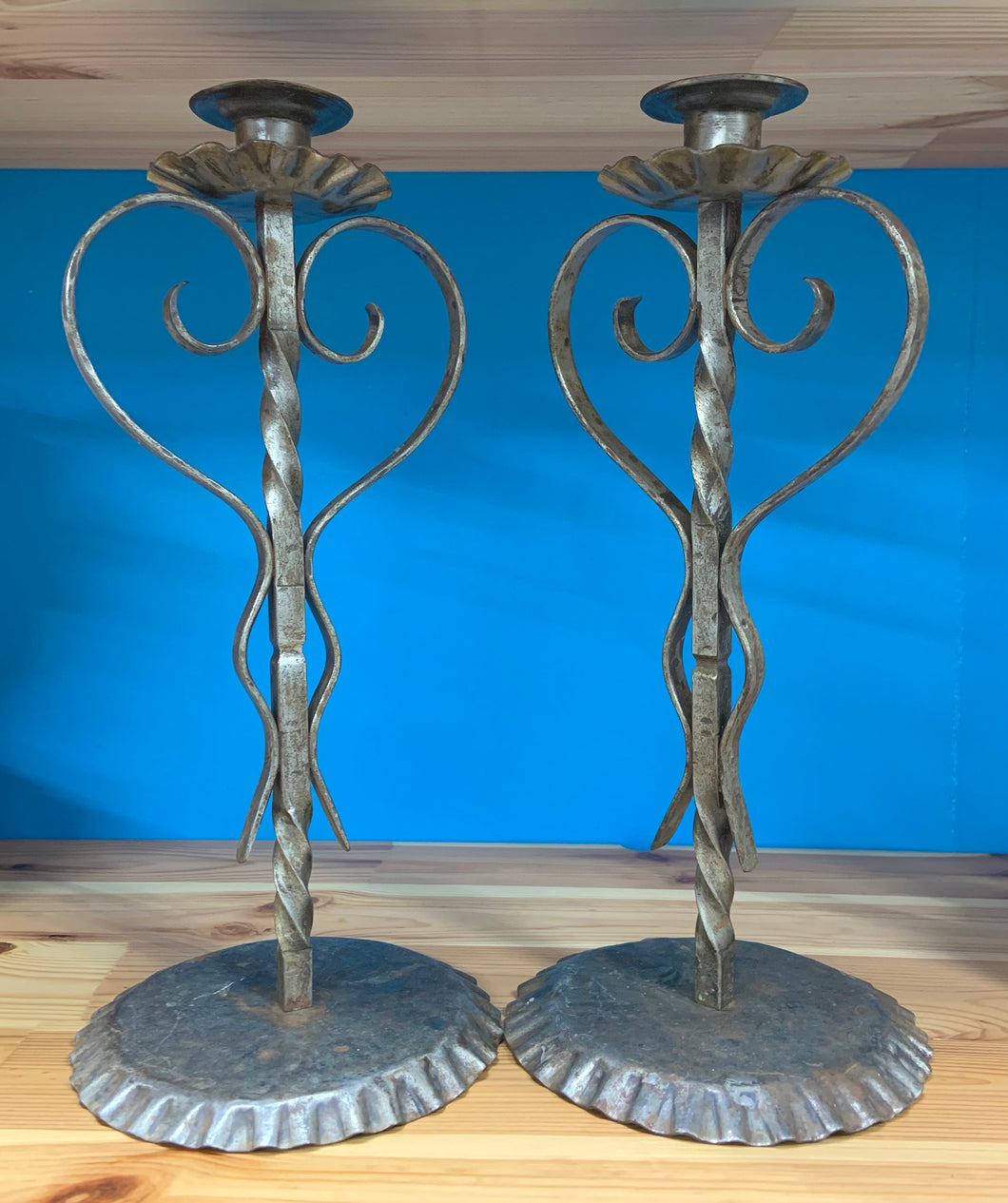 A fabulous pair of hand-forged iron candlesticks. In excellent vintage condition.  Measures approximately 12