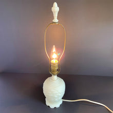 Load image into Gallery viewer, A stunning creamy white cased satin glass table lamp which has a raised pagoda scene with trees and birds with bakelite collar and final. Japan, circa 1950. Perfect for a bedside lamp, or as an accent light in an entranceway or bedroom.  Excellent condition, free from chips or cracks, some wear on the bakelite collar. In good working order.  Size: glass base 4.5&quot; x 6.5&quot;; overall height 18.5&quot; (including finial)

