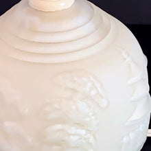 Load image into Gallery viewer, A stunning creamy white cased satin glass table lamp which has a raised pagoda scene with trees and birds with bakelite collar and final. Japan, circa 1950. Perfect for a bedside lamp, or as an accent light in an entranceway or bedroom.  Excellent condition, free from chips or cracks, some wear on the bakelite collar. In good working order.  Size: glass base 4.5&quot; x 6.5&quot;; overall height 18.5&quot; (including finial)
