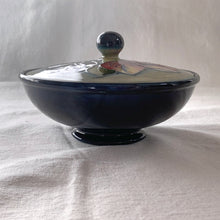 Load image into Gallery viewer, Vintage mid-century &quot;Clematis&quot; lidded dish with green ground lid and teal/blue ground on bowl&#39;s interior and deep blue on the exterior of the bowl. The colours are vibrant and the tube lining and hand painting are spectacular. Produced by Moorcroft Pottery, England, circa 1950s.  Measures 6-1/4&quot; x 3-1/2&quot;  Excellent condition. No cracks or chips. Normal crazing for a piece of this age. Impressed marks include Walter Moorcroft&#39;s signature, Potter to H.M. The Queen and Made in England.
