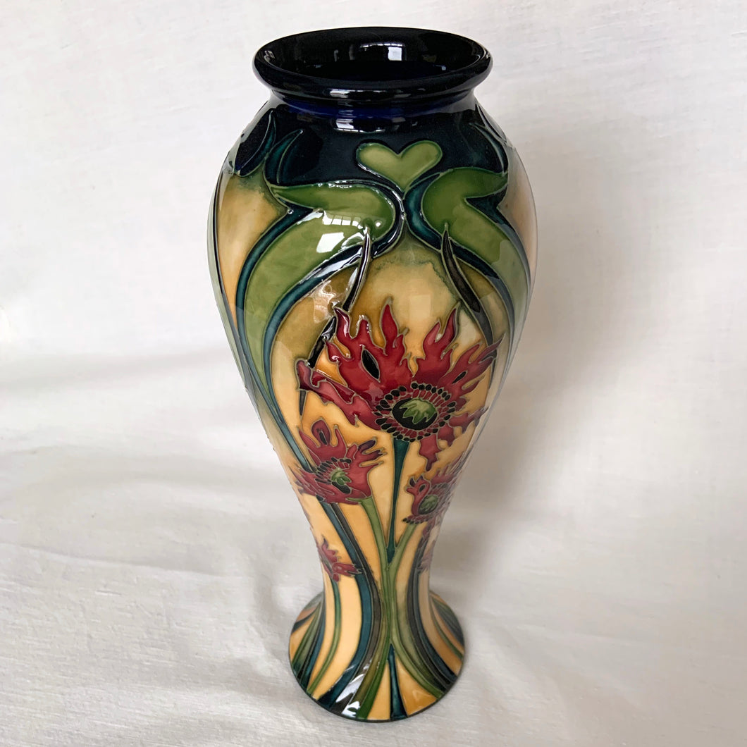 Vintage hand painted Ragged Poppy limited edition art pottery vase, number 113/350.  Designed by Nicole Slaney in 2003. This piece is hand painted over slip glaze with a deep blue ground in shades of yellow, green and red on shape 75/10. Produced by Moorcroft Pottery, Stoke-on-Trent England. Excellent condition, no chips, cracks or repairs. First quality. Maker's marks, edition and signed by the artist on the bottom, see photos. Measures 4-1/2