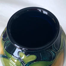 Load image into Gallery viewer, Vintage hand painted Ragged Poppy limited edition art pottery vase, number 113/350.  Designed by Nicole Slaney in 2003. This piece is hand painted over slip glaze with a deep blue ground in shades of yellow, green and red on shape 75/10. Produced by Moorcroft Pottery, Stoke-on-Trent England. Excellent condition, no chips, cracks or repairs. First quality. Maker&#39;s marks, edition and signed by the artist on the bottom, see photos. Measures 4-1/2&quot; x 11&quot;
