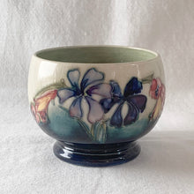 Load image into Gallery viewer, The sweetest pattern of &quot;Spring Flowers&quot; adorns this open sugar bowl. Hand crafted by Moorcroft Pottery, England, circa 1950s.  In excellent condition, free from chips/cracks/repairs, with normal crazing for a piece of this age.  Impressed with Walter Moorcroft&#39;s signature, &quot;H.M. Potter To The Queen&quot; and &quot;Made in England&quot;  Measures 3 3/4 x 2 3/4 inches
