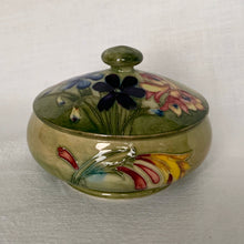 Load image into Gallery viewer, A gorgeous lidded trinket dish in the colourful &quot;Spring Flowers&quot; pattern, on green ground. Produced by Walter Moorcroft, Moorcroft Pottery, England, circa 1950s.  Size: 4-1/2&quot; x 3-1/4&quot;  In excellent condition, free from chips/cracks/repairs, with normal crazing for a piece of this age.  From our personal collection.
