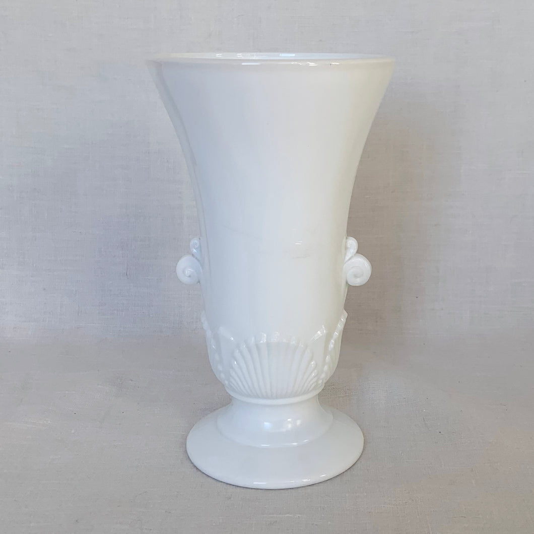 Beautifully detailed art deco style, opaque white glass vase. Pretty scroll handles and a scalloped shell motif in a tapered urn shape.  In excellent condition, free from chips or cracks. Marked 