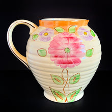 Load image into Gallery viewer, Hand painted art deco pitcher produced by Kensington Ware, England, circa 1940. Vibrant shades of pink, purple, green, yellow and orange against the creamy background with gold detail make this piece bright and cheery. Perfect as a display piece or as a vase filled with a beautiful bouquet of flowers. In excellent vintage condition, no chips with light crazing. There appears to be a crack on the interior, but it may just be crazing as it does not go through to the exterior. 
