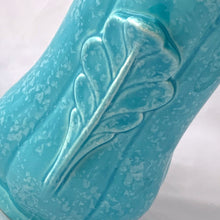 Load image into Gallery viewer, A lovely art deco style vintage vase in sky blue with white speckles. Adorned on either side with a dimensional leaf motif and subtle feminine fluted body. A beautiful vase to use as a decor piece or fill it with a beautiful bouquet of flowers!  In good vintage condition, 2 minor flea bites on the rim which aren&#39;t too noticeable thanks to the white speckled glaze. No cracks or repairs.  Measures 5 x 8 3/4 inches
